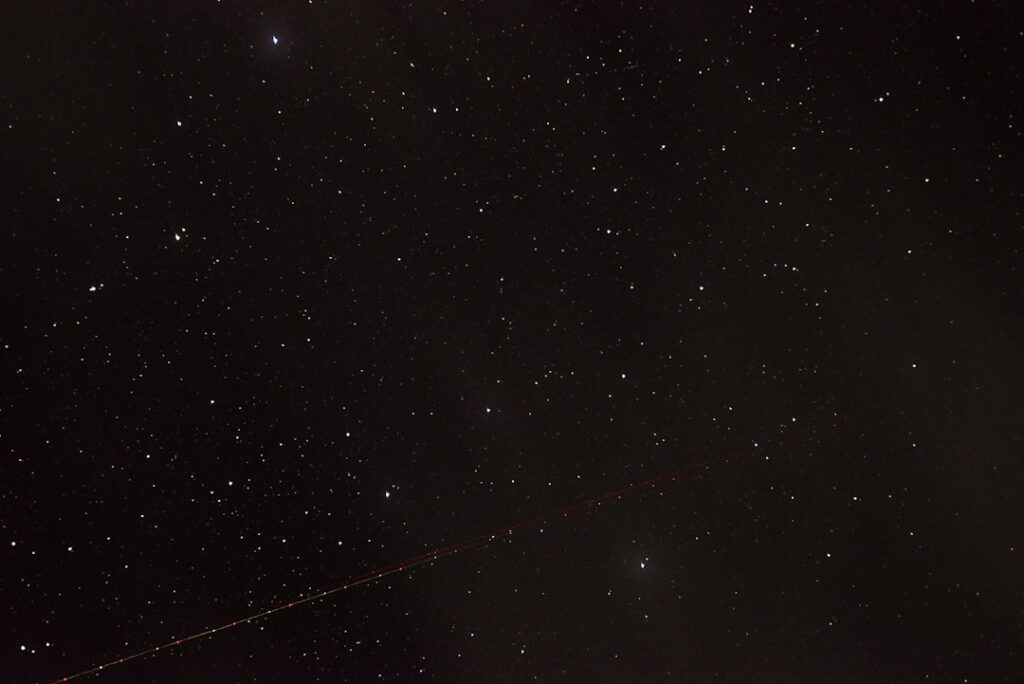 the night sky with stars and a long line of lines