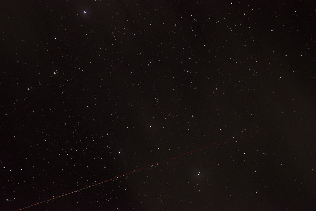 the night sky with stars and a long line of lines